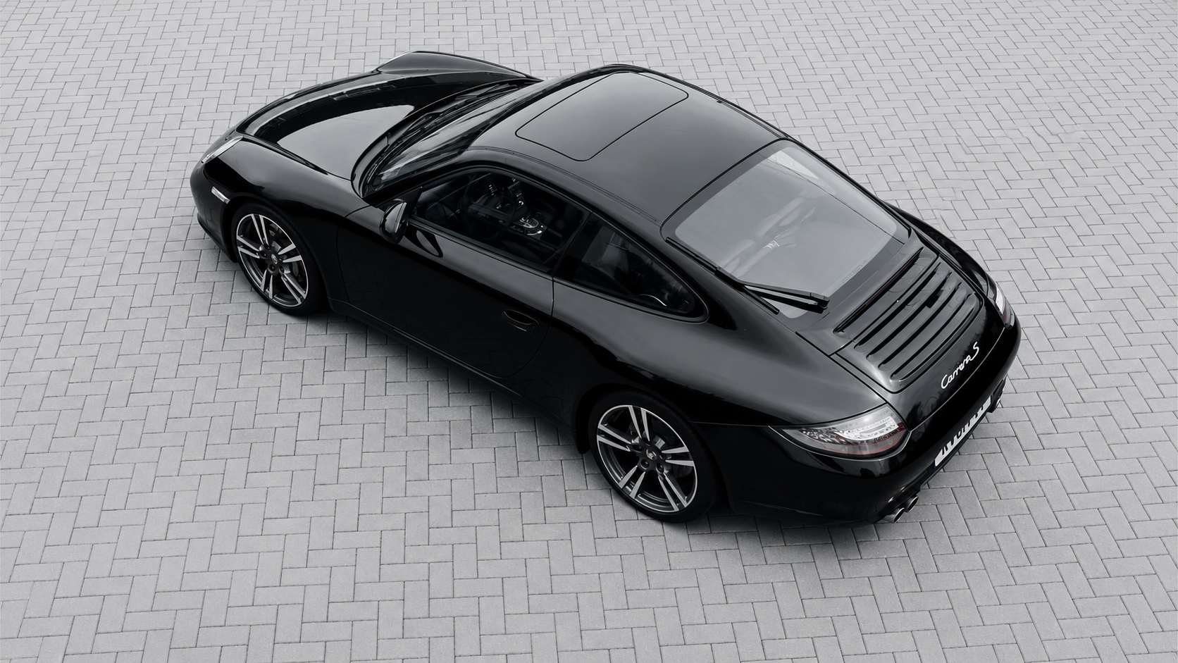 Porsche 911 997 Gen2 S on herringbone pavers, viewed from above.